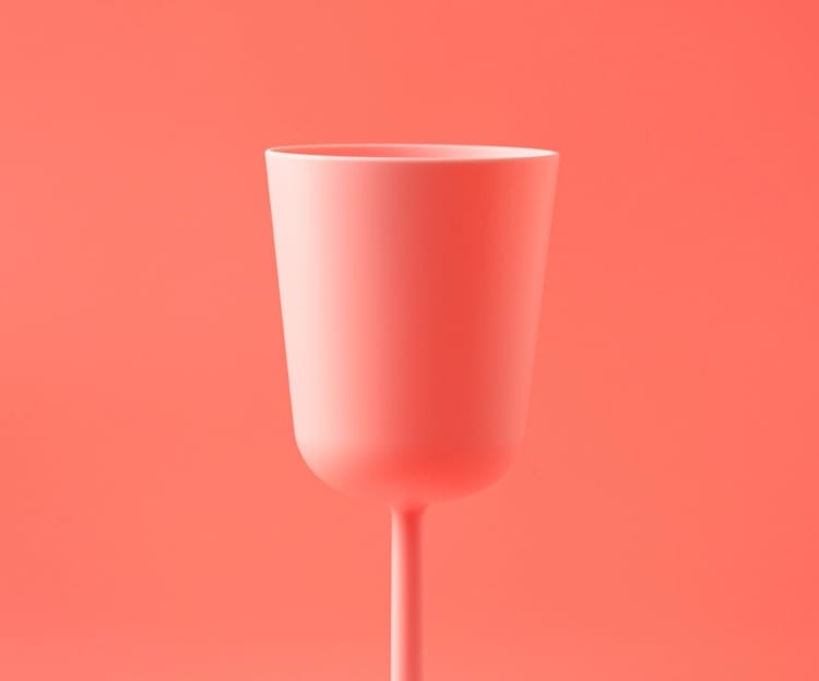 a pink glass on a pink background